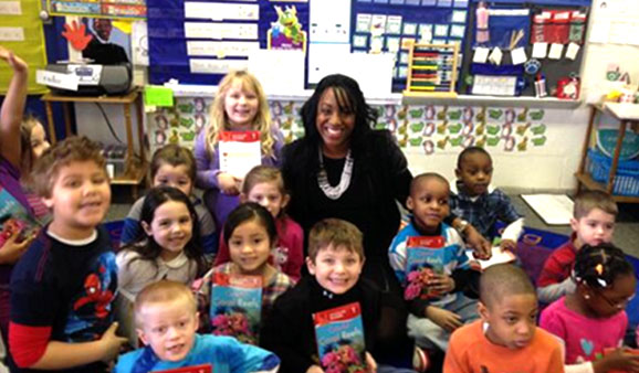 Employees read to first graders at Garfield Elementary School in Michigan